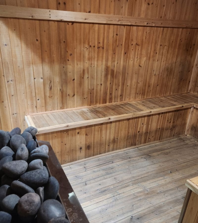 Wood-paneled sauna room at Powerhouse Gym Linden designed for post-workout relaxation and muscle recovery.